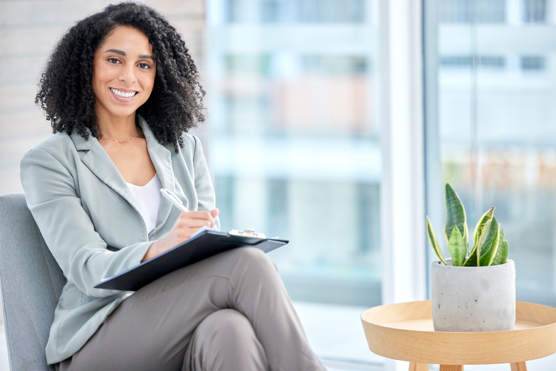 Black woman, therapist portrait and checklist for counselling, help or smile for happiness in office. African psychologist, clipboard and happy for advice, listening or conversation for mental health
